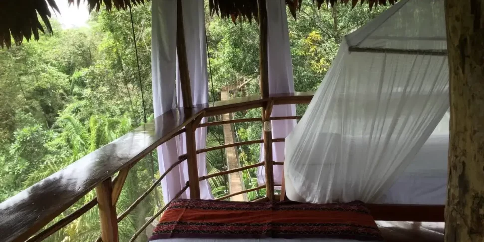 Bed inside casa alta treehouse at the treehouse lodge in peru.