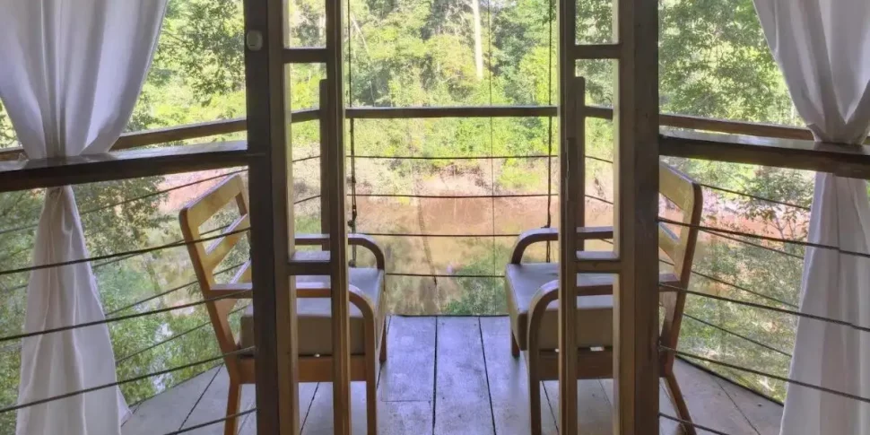 Mini balcony area in the costa bella treehouse with seating at the treehouse lodge in peru.